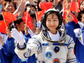 Liu Yang, China's first female astronaut, waves during a departure ceremony at Jiuquan Satellite Launch Center, Gansu province